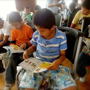 Boy sitting and reading a OneHope book