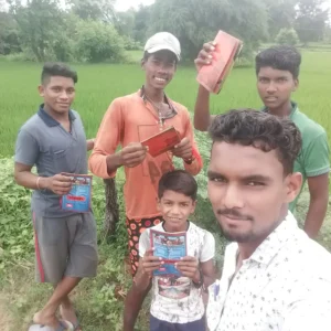 group of boys of different ages holding a OneHope book.